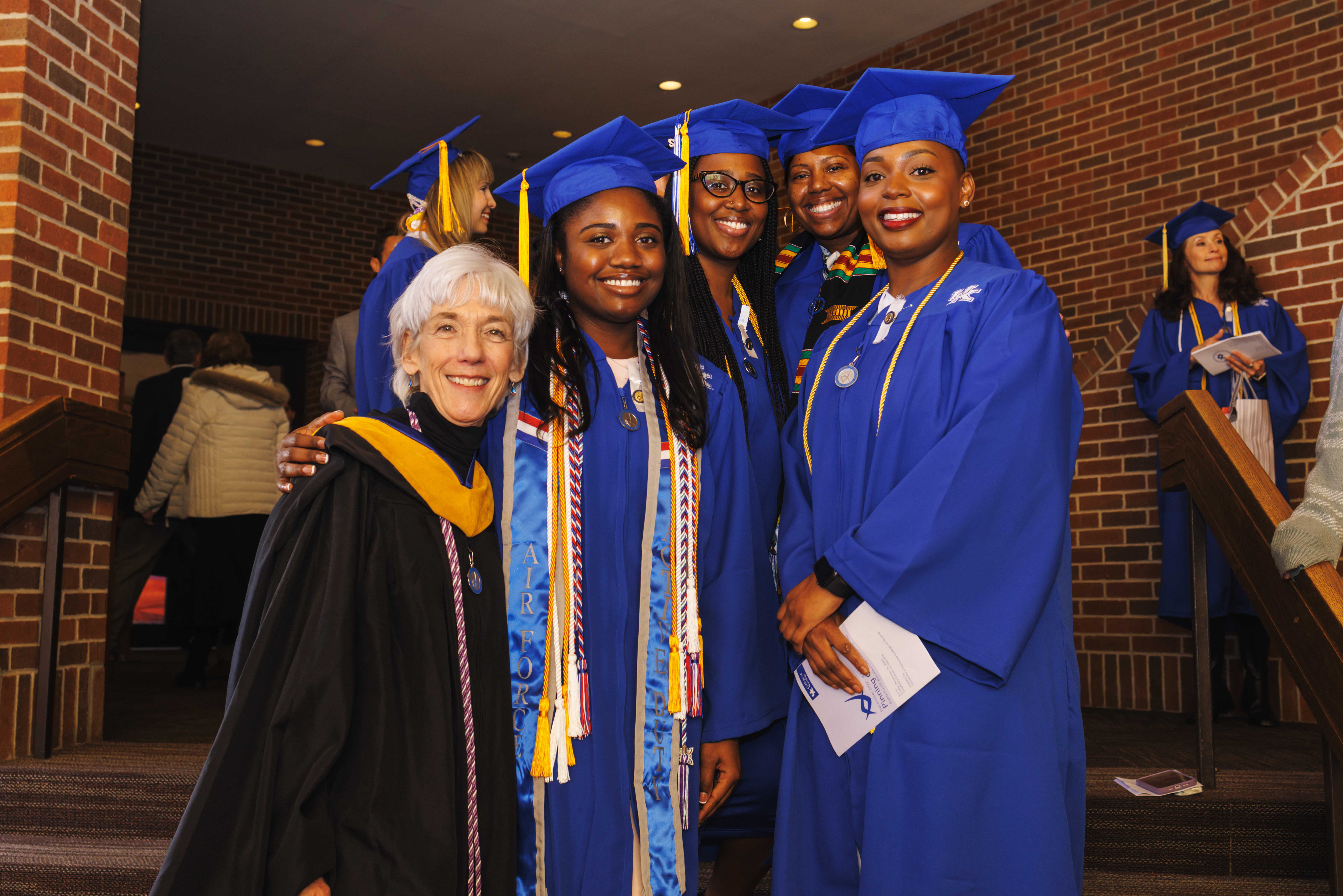 Students posing with faculty at Pinning Ceremony