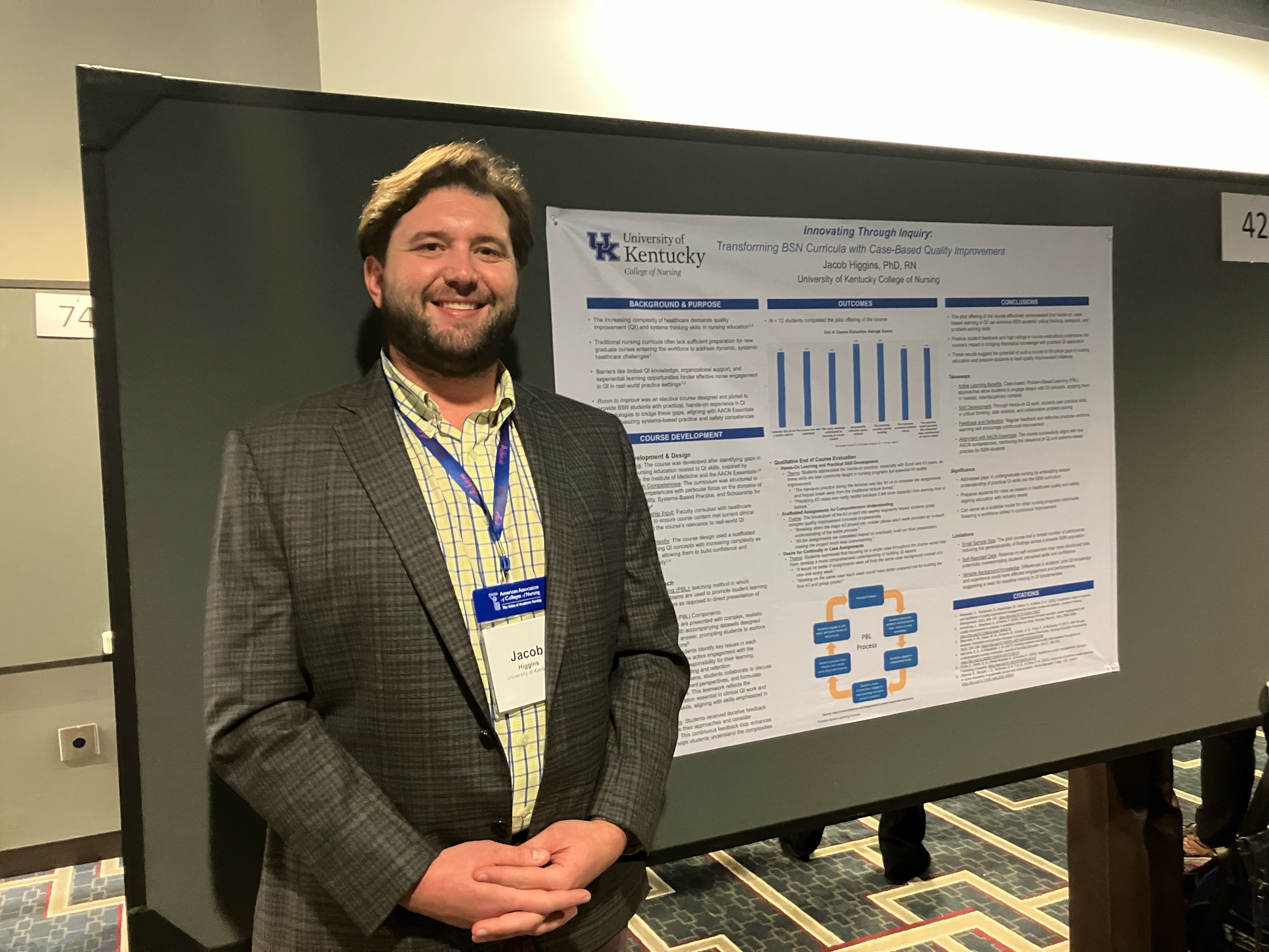 A man standing in front of a research poster. 