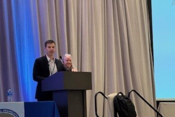 Two people standing behind a podium. 