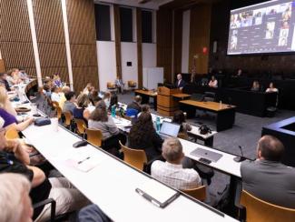 People sitting at the university senate meeting