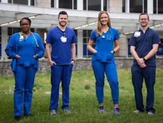 Nurses posing together outside of the UK hospital. 