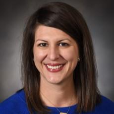 A headshot photo of a woman smiling. 