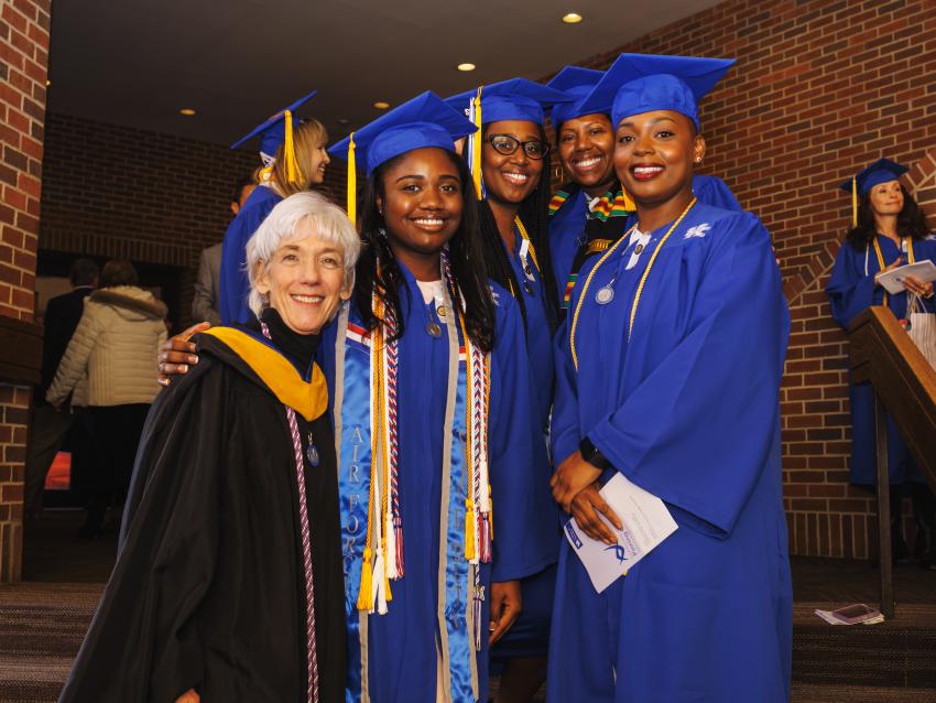 Students posing with faculty at Pinning Ceremony