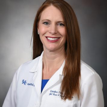 Woman with red hair in a white doctor's coat