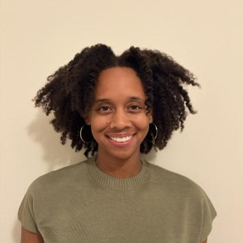 Headshot photo of Gabrielle innocent smiling and wearing a green shirt. 