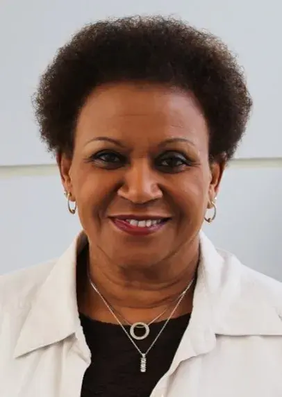 A headshot photo of a woman smiling.