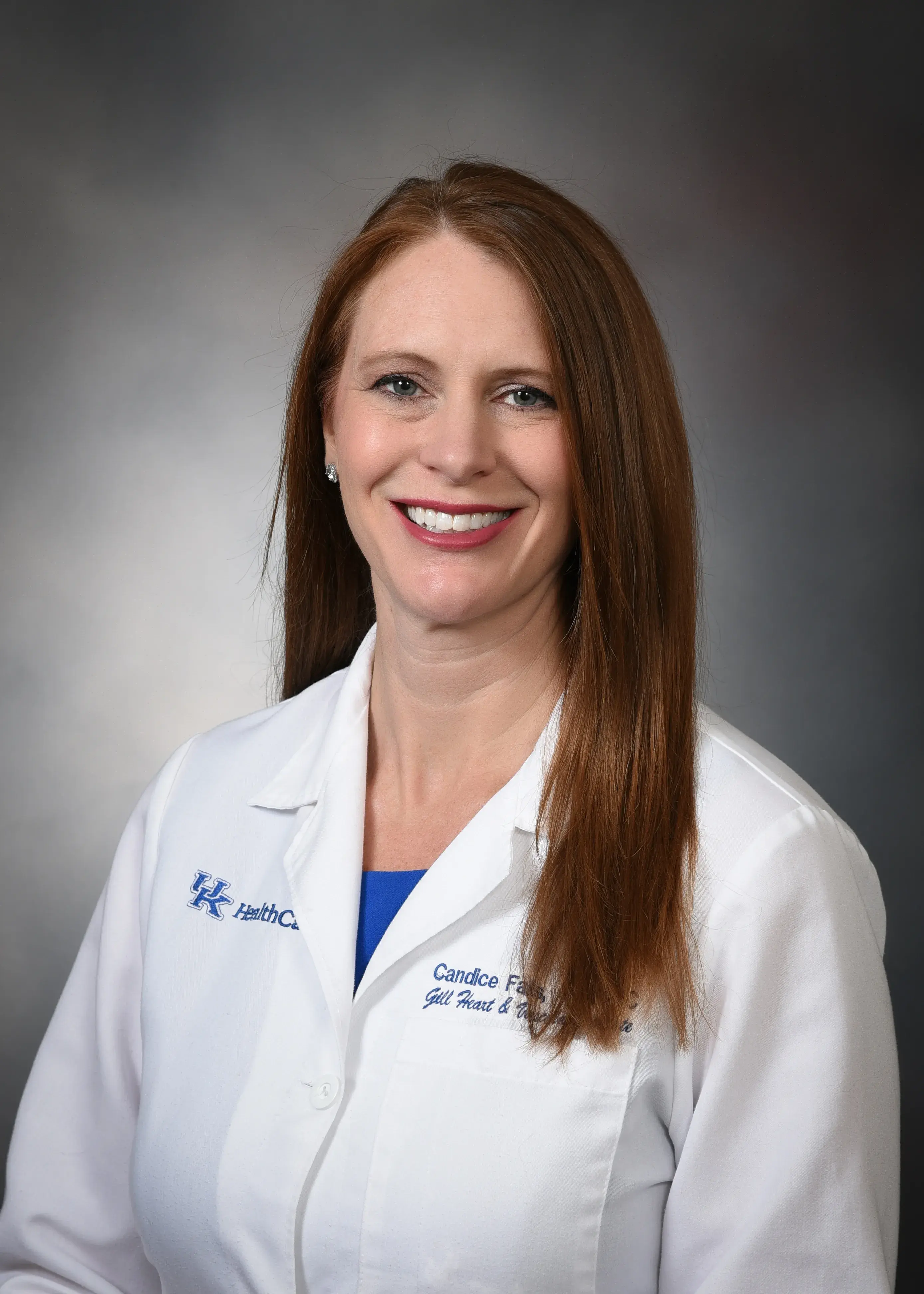 Woman with red hair in a white doctor's coat