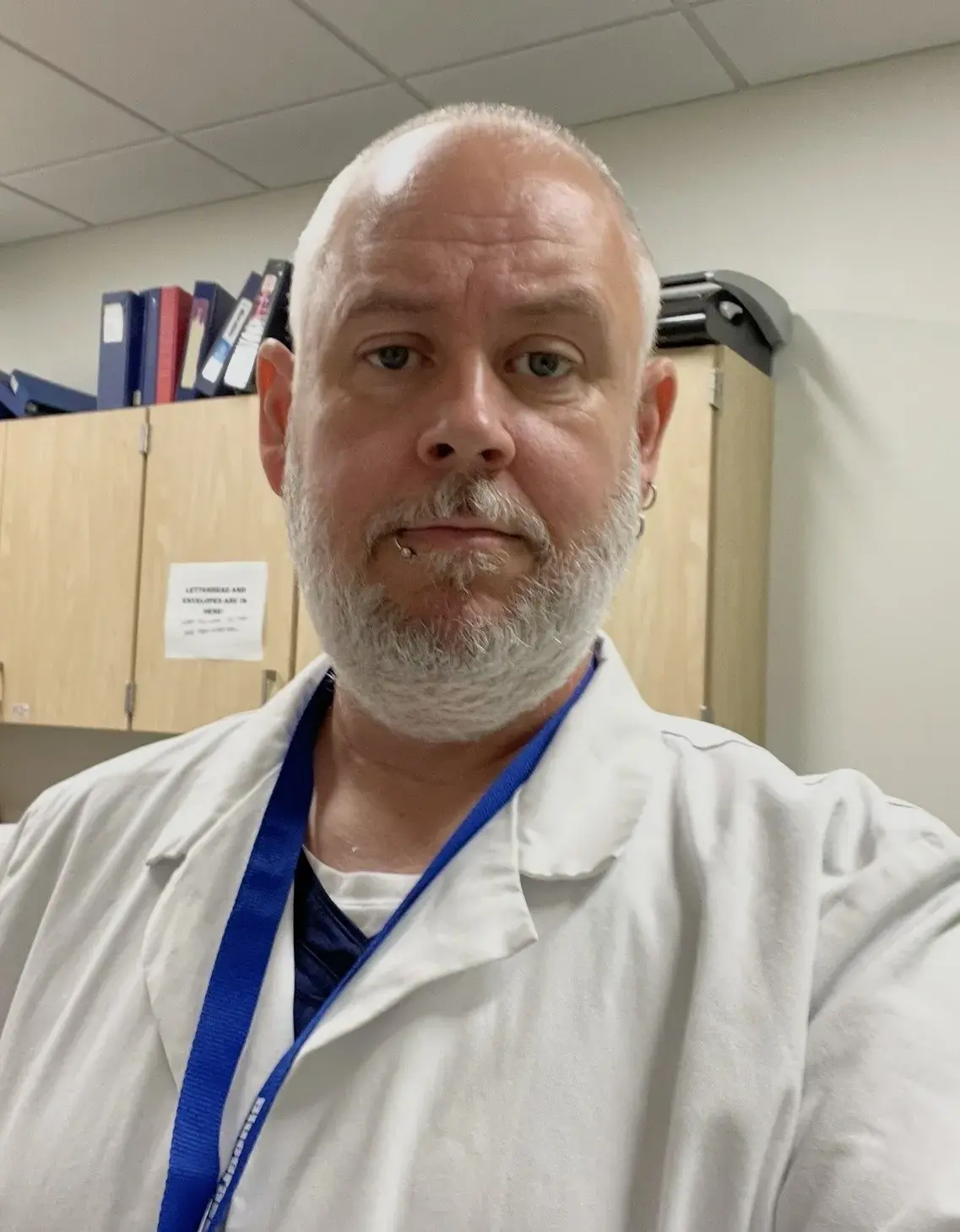 Photo of James Davis. He is wearing a medical whitecoat. 