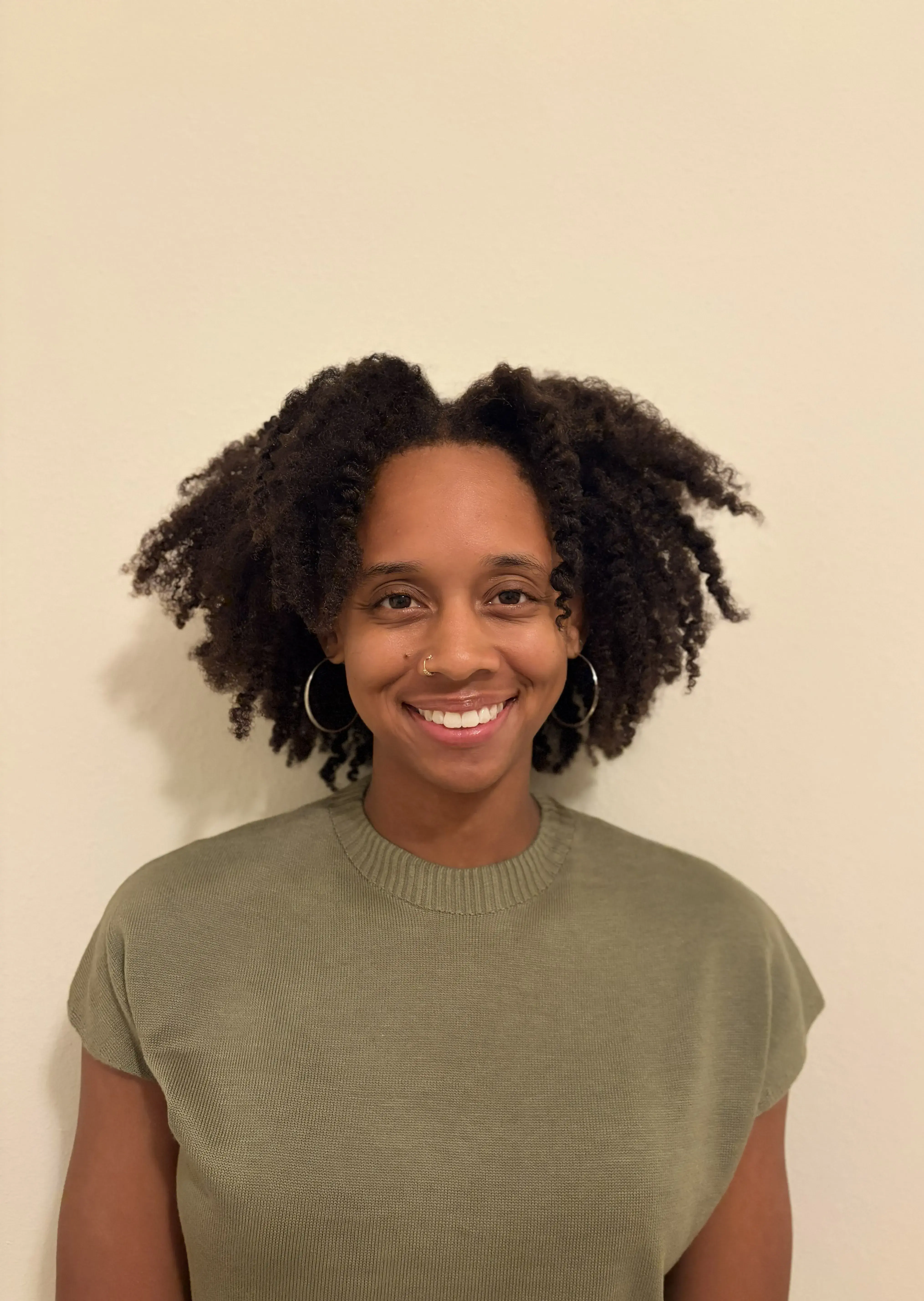 Headshot photo of Gabrielle innocent smiling and wearing a green shirt. 